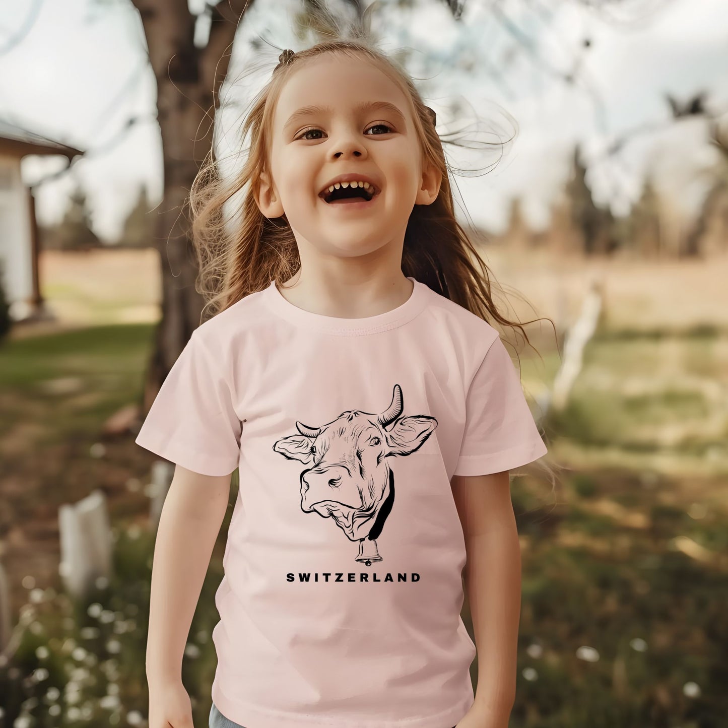 Happy toddler wearing a Switzerland cow t-shirt outdoors