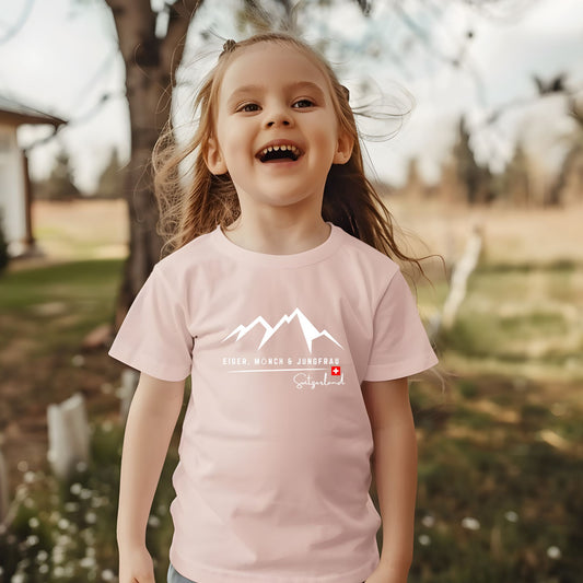 Toddler wearing Eiger Mรถnch Jungfrau Switzerland mountain t-shirt in pink