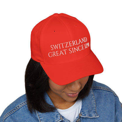 Woman wearing red Switzerland Great Since 1291 embroidered baseball cap, angled front view showing embroidered text and structured mid-profile crown
