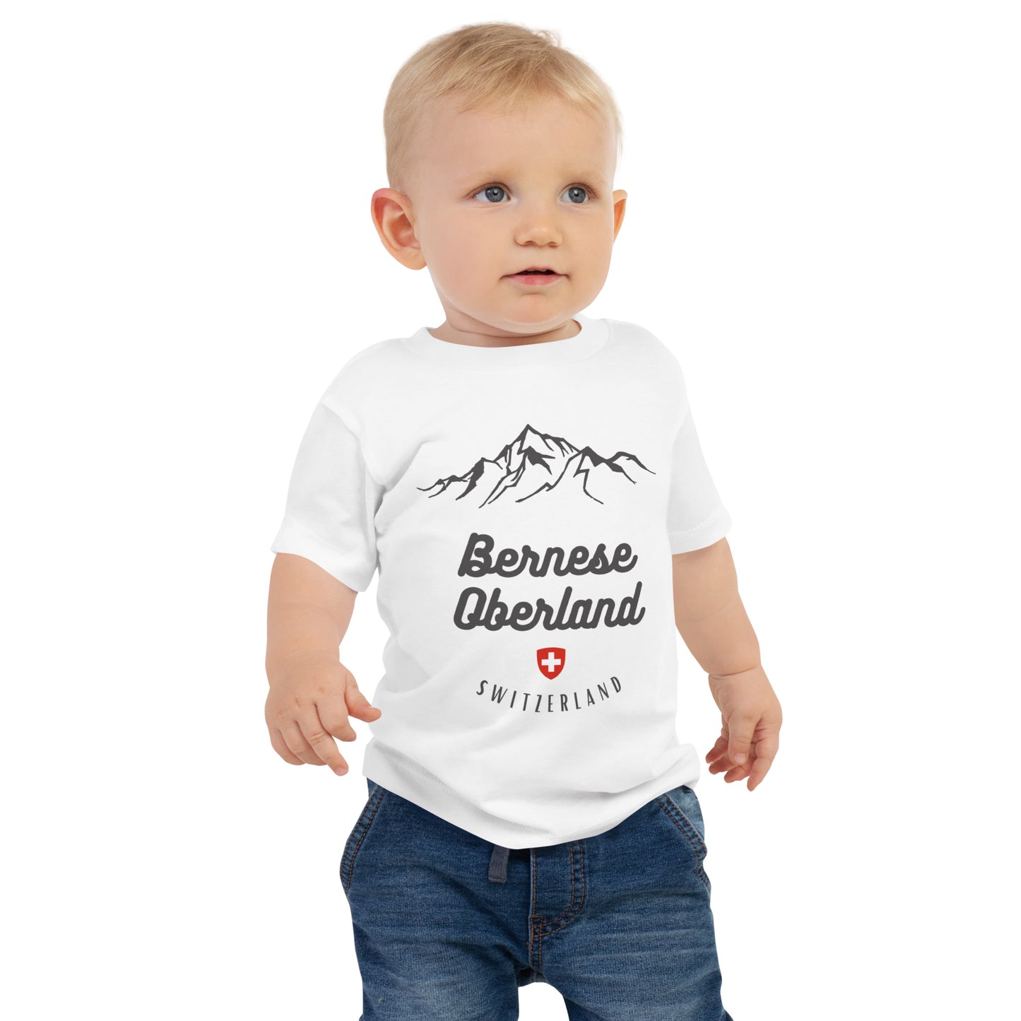 Baby wearing Bernese Oberland Switzerland adventure t-shirt in white.