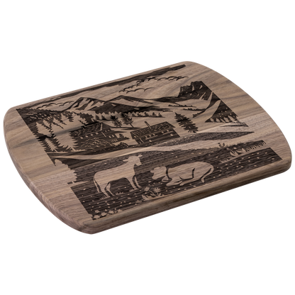 Swiss-inspired cutting board with Binntal Nature Park papercut design showing traditional chalet and grazing cow in alpine village setting, perfect for kitchen decor