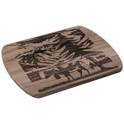 Swiss cow cutting board with scherenschnitte silhouette design featuring Glarus peaks and Elm Sernftal alpine scenery in premium wood