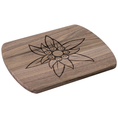 Angled view of dark wood Swiss Edelweiss cutting board showing rounded edges and detailed flower engraving
