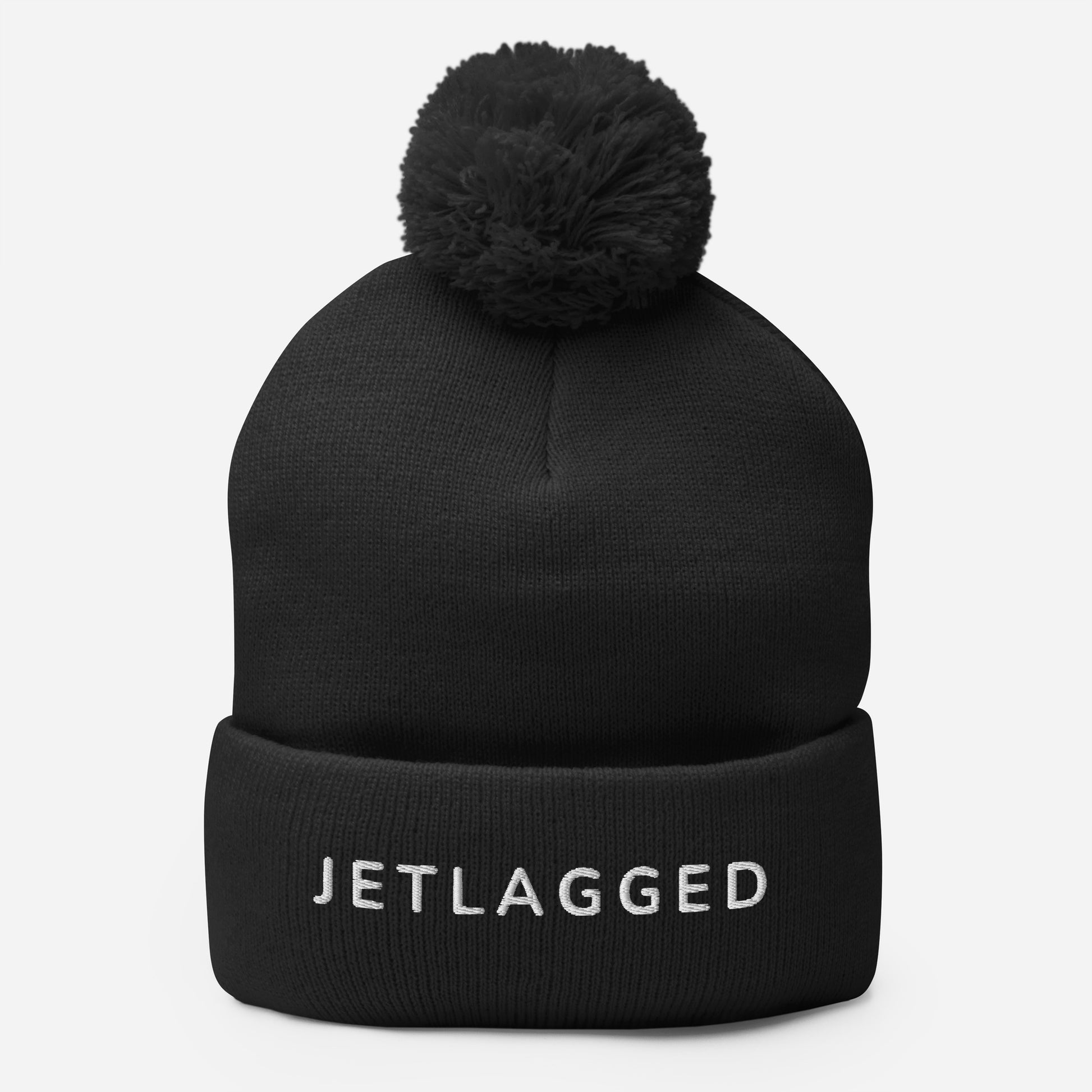 Embroidered Jetlagged pom-pom beanie in navy, black, and dark heather gray