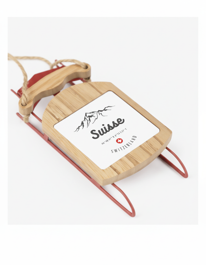 Wooden Suisse sled ornament featuring Swiss Alps and red Swiss cross