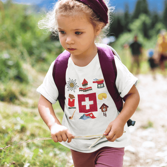 Girl wearing a Swiss travel-themed t-shirt featuring iconic elements of Switzerland's landscapes and culture. Perfect for young adventurers with a passion for exploring