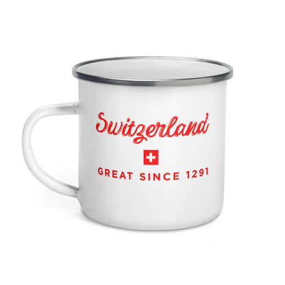 A white enamel camp mug with a silver metal rim, featuring red text that reads 'Switzerland' and 'GREAT SINCE 1291' with a small Swiss flag on the front.