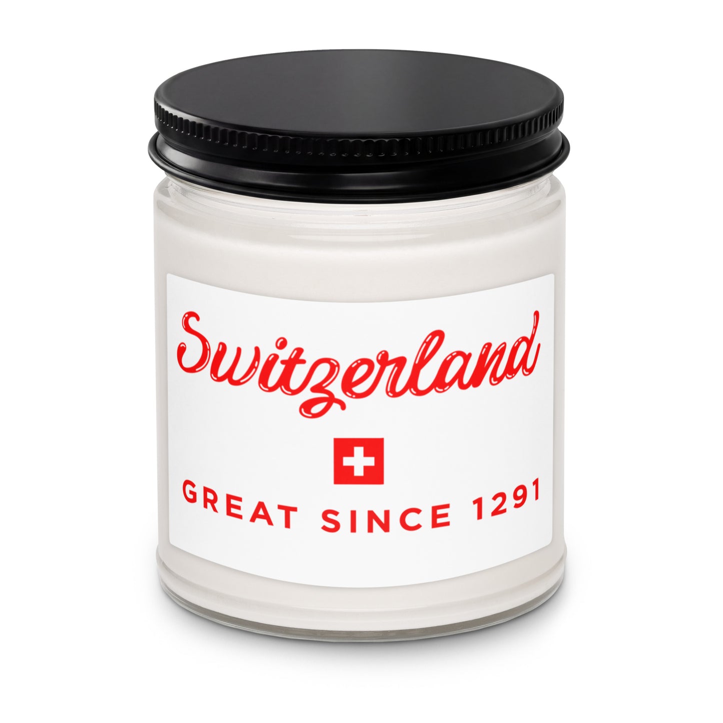 A white glass jar candle with a black metal lid and a white label featuring red text that reads 'Switzerland' and 'GREAT SINCE 1291' with a small Swiss flag icon.