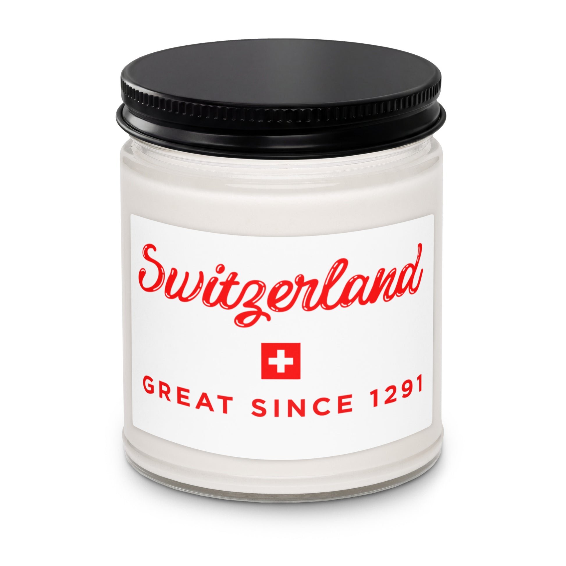 A white glass jar candle with a black metal lid and a white label featuring red text that reads 'Switzerland' and 'GREAT SINCE 1291' with a small Swiss flag icon.