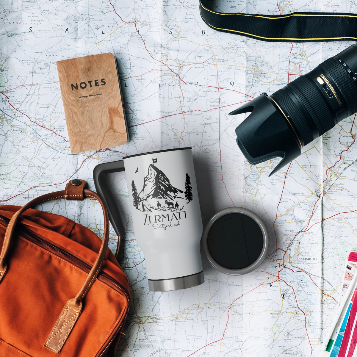 Zermatt Switzerland travel mug styled with camera, map, and backpack for hiking adventure flatlay