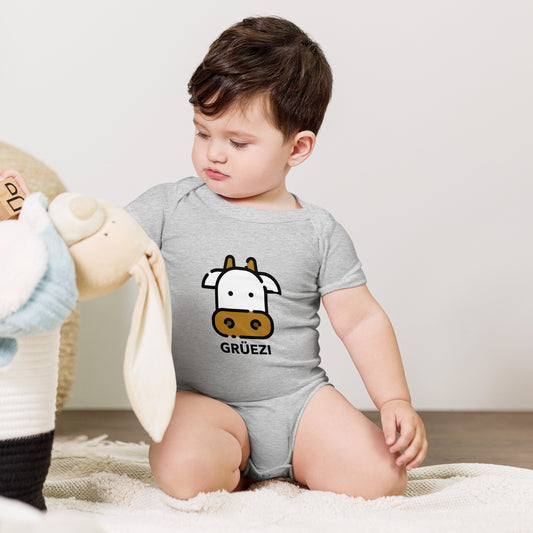 Grüezi baby onesie featuring cartoon cow and playful design