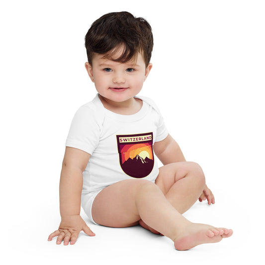 Baby in white Switzerland mountain badge onesie with retro design.