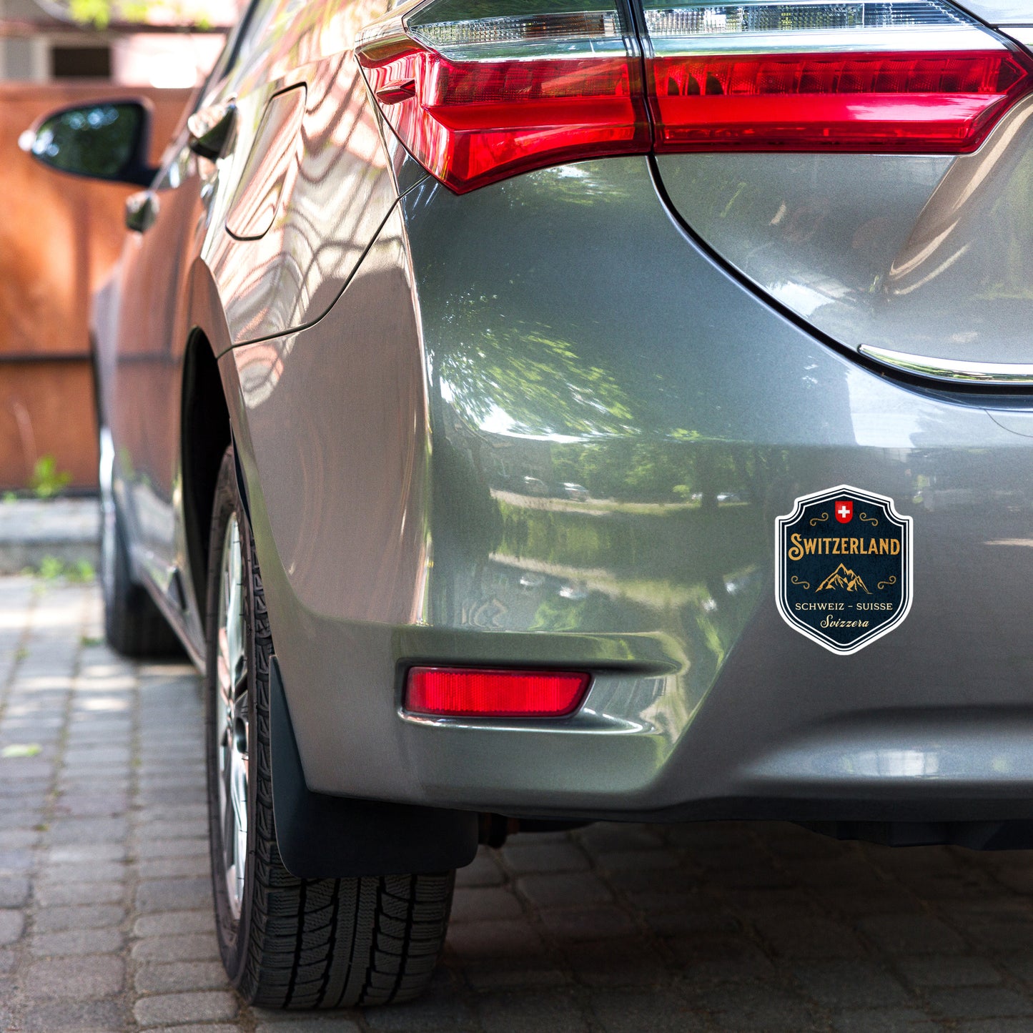 Swiss souvenir sticker featuring Alpine mountains and Switzerland emblem