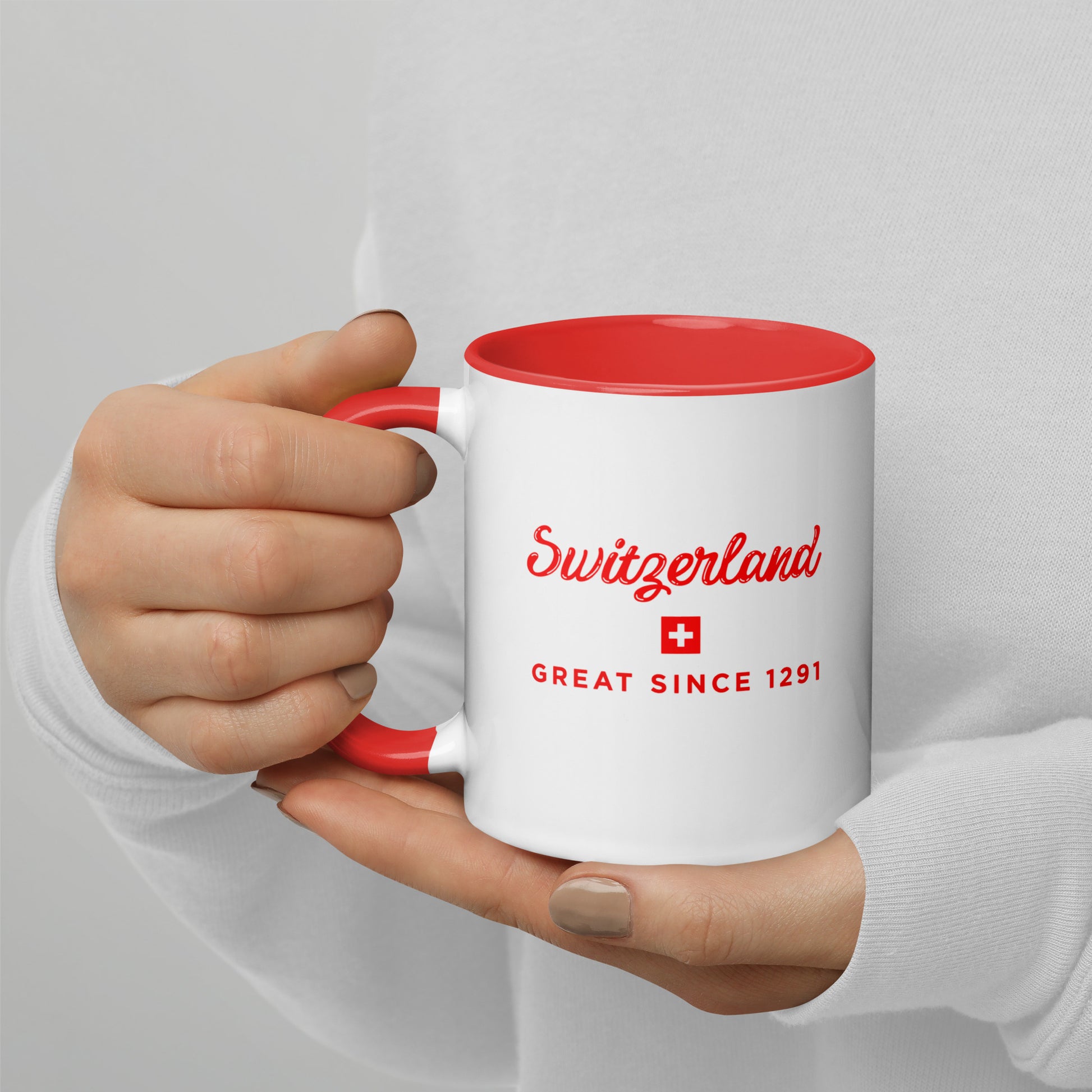 white 11 oz ceramic mug with red interior and handle, featuring Switzerland Great Since 1291 design with Swiss cross – perfect Swiss gift